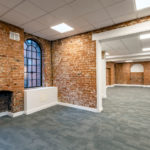 Exposed red brick walls inside Empire Court offices to rent Redditch