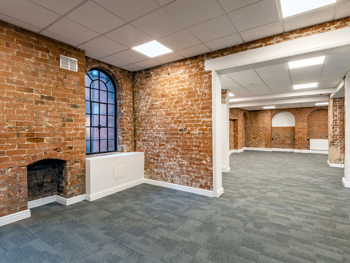 Exposed red brick walls inside Empire Court offices to rent Redditch