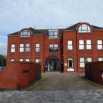 Red brick exterior of Corner Oak offices to let Solihull at 1 Homer Road
