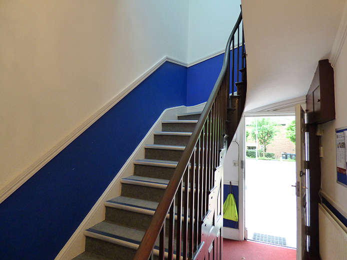 Internal view of stairs and front door leading onto car park - offices Birmingham