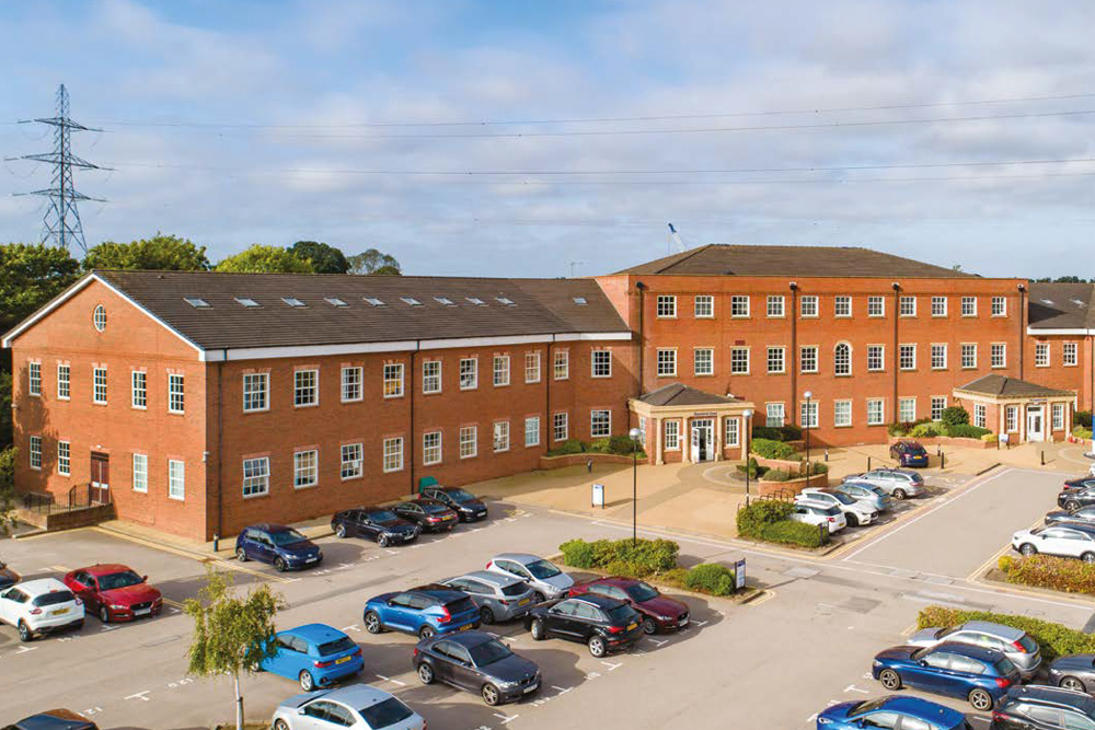 Exterior and car park of Bromwich Court, offices in Coleshill, M42 J7