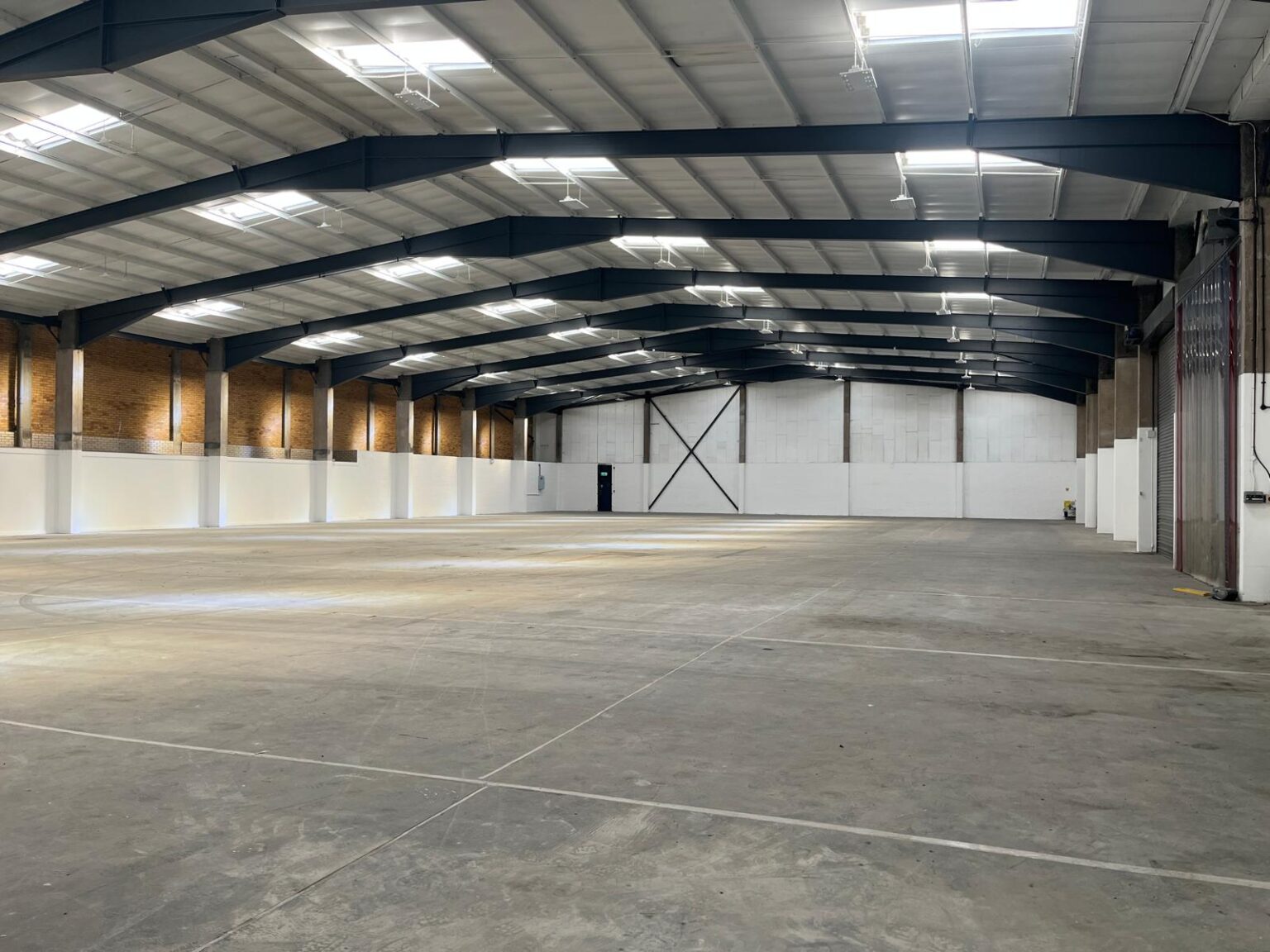 Internal view of a warehouse at refurbished Birmingham industrial estate where a duo of lettings has been agreed - Tamebridge Industrial Estate, Perry Barr, Birmingham