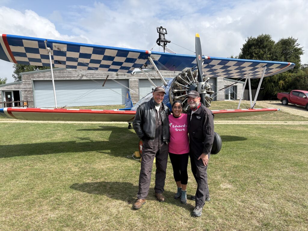 Narinder preparing to take to the skies strapped to the wings of a Boeing Stearman biplane